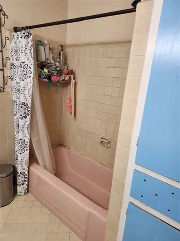 a bathroom with a bathtub and shower