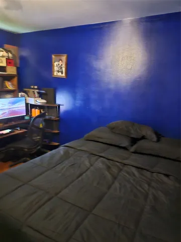 a bedroom with a bed and a book shelf