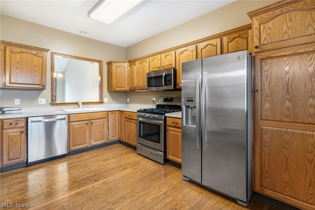2414 Charing Cross Road Northwest Canton, OH 44708 - Photo 7 of 36 Kitchen featuring stainless steel appliances, sink, and light hardwood / wood-style floors