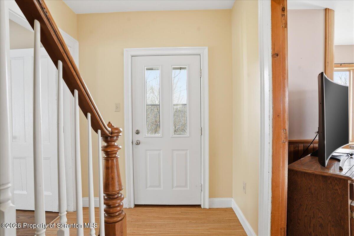 795 Wescott Road New Milford, PA 18834 - Photo 17 of 81 a view of a livingroom with wooden floor and staircase