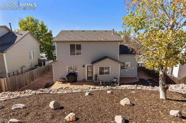 a front view of a house with a yard garage and outdoor seating