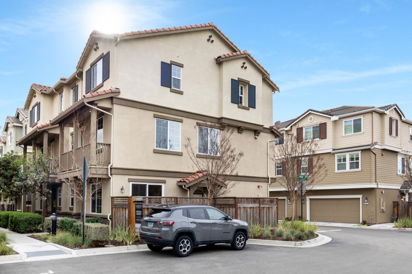 a car parked in front of a white house