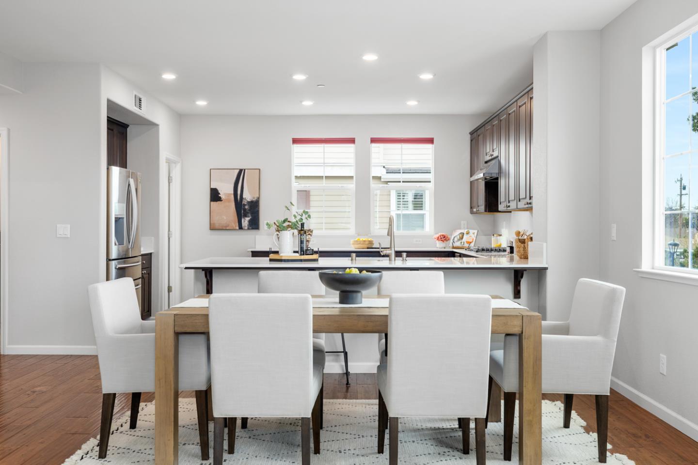 2208 Rosenblatt Street Hayward, CA 94544 - Photo 12 of 32 a kitchen with stainless steel appliances granite countertop a dining table chairs refrigerator and cabinets