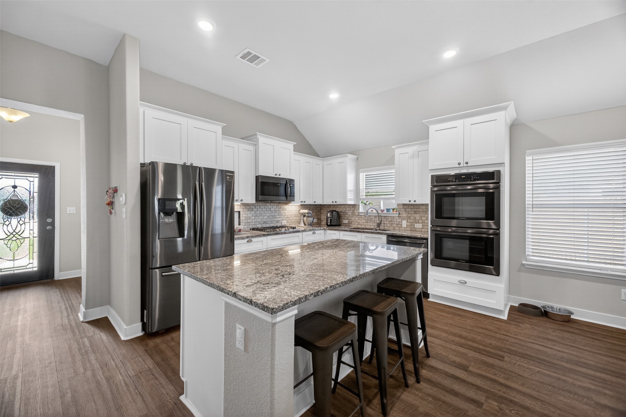 1009 Bright Star Cove Georgetown, TX 78628 - Photo 3 of 40 a kitchen with stainless steel appliances granite countertop a refrigerator and a stove top oven