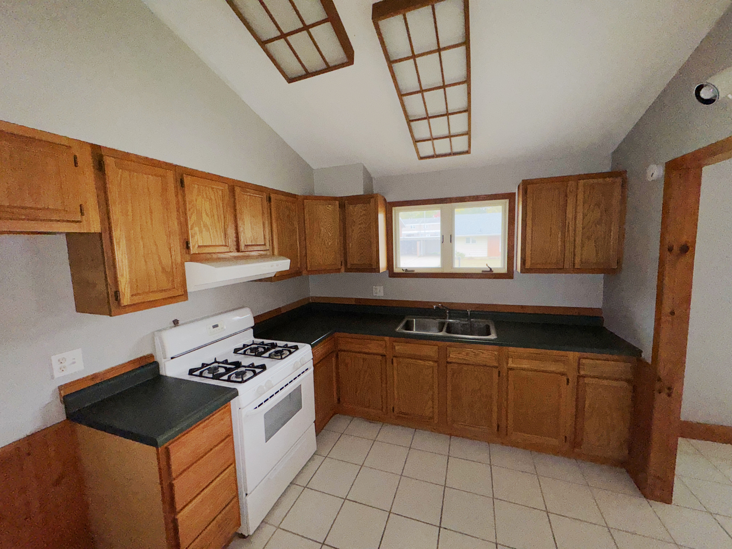 1612 Golfview Road Rantoul, IL 61866 - Photo 11 of 46 a kitchen with granite countertop a sink a stove and cabinets