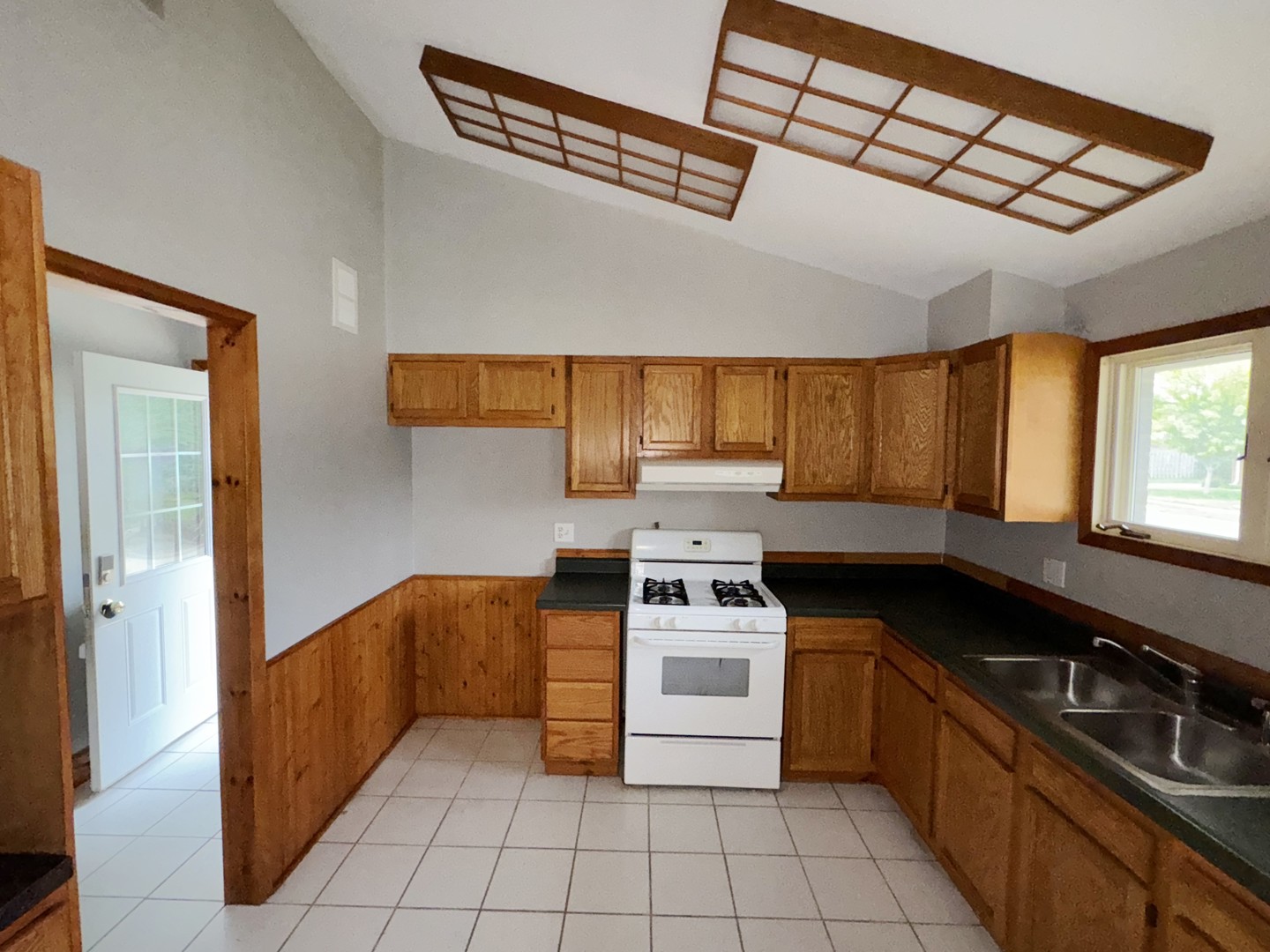 1612 Golfview Road Rantoul, IL 61866 - Photo 12 of 46 a kitchen with stainless steel appliances a stove sink and cabinets