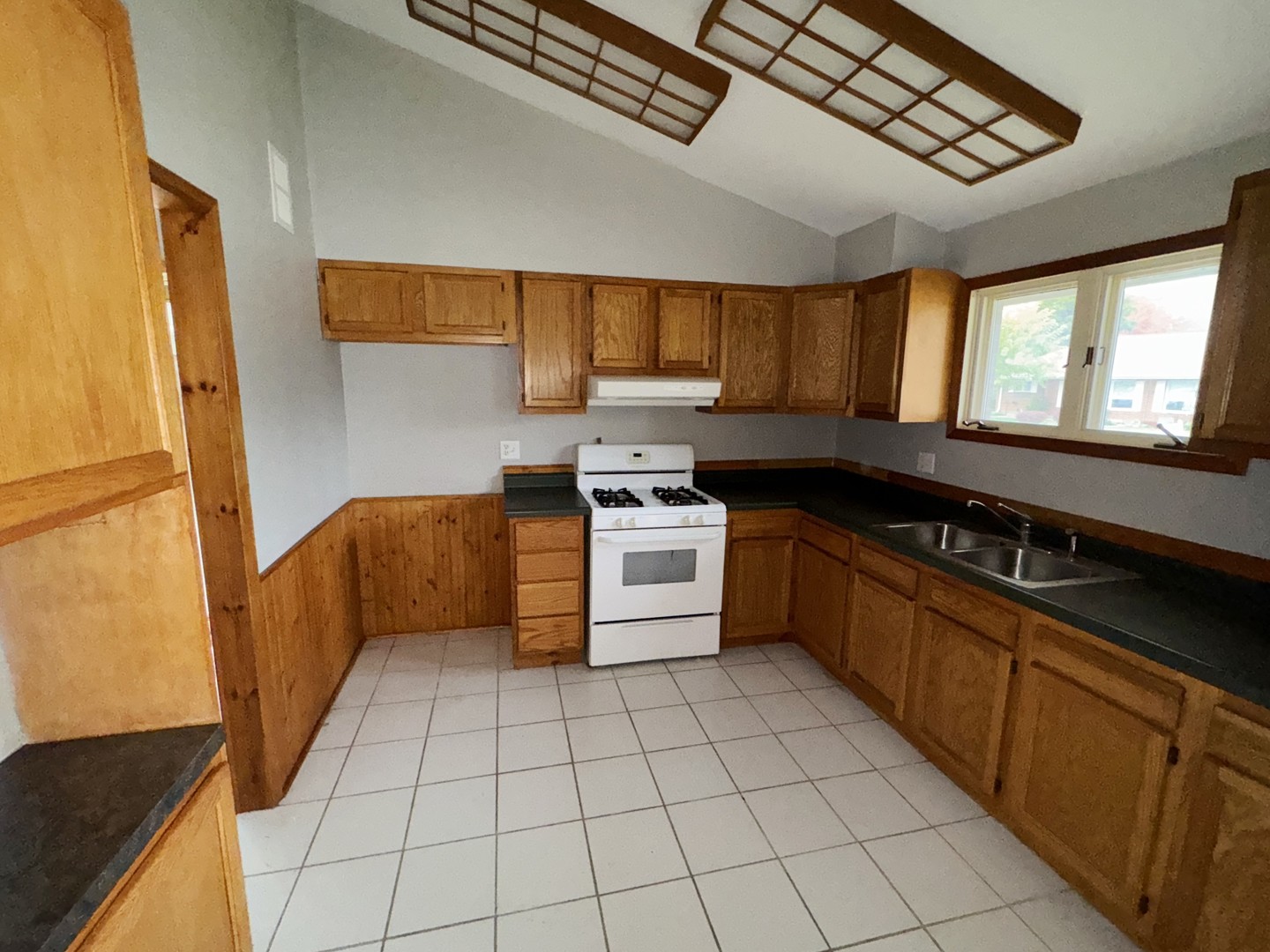 1612 Golfview Road Rantoul, IL 61866 - Photo 14 of 46 a kitchen with a stove sink and cabinets