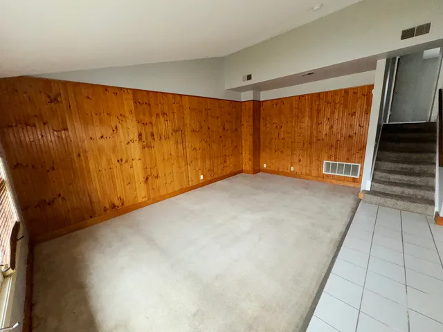 an empty room with furniture and window