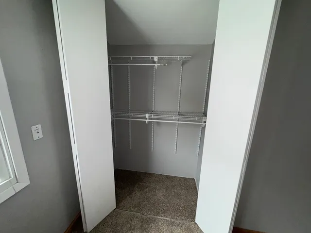 an empty room with a empty space and windows