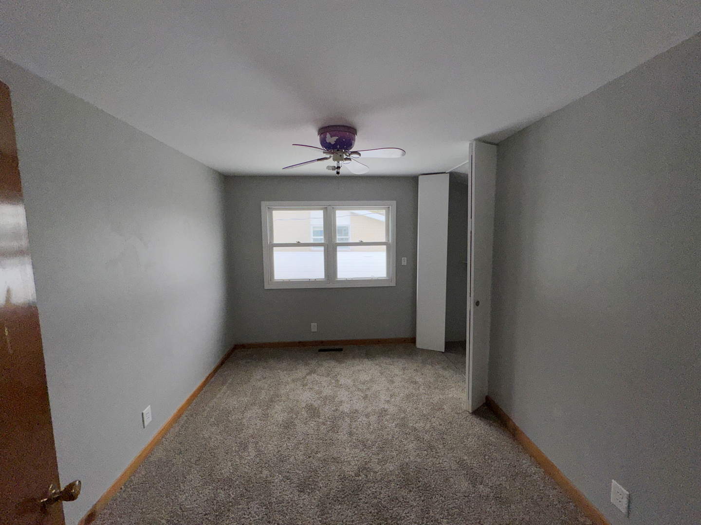 1612 Golfview Road Rantoul, IL 61866 - Photo 25 of 46 an empty room with windows and a ceiling fan