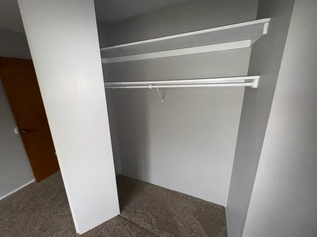 a white toilet sitting next to a window