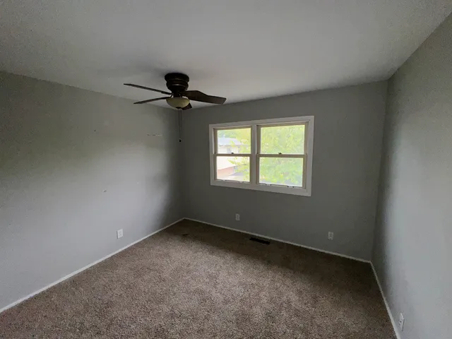 a bathroom with a bathtub shower sink vanity and a toilet