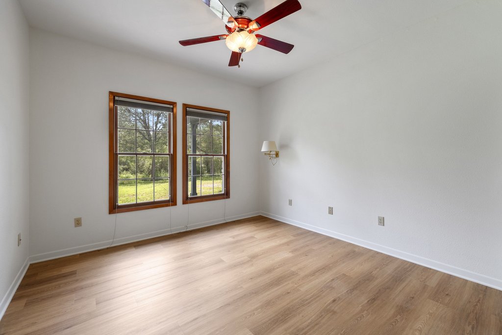 244 Woodway Elgin, TX 78621 - Photo 11 of 40 a view of an empty room with window and chandelier fan