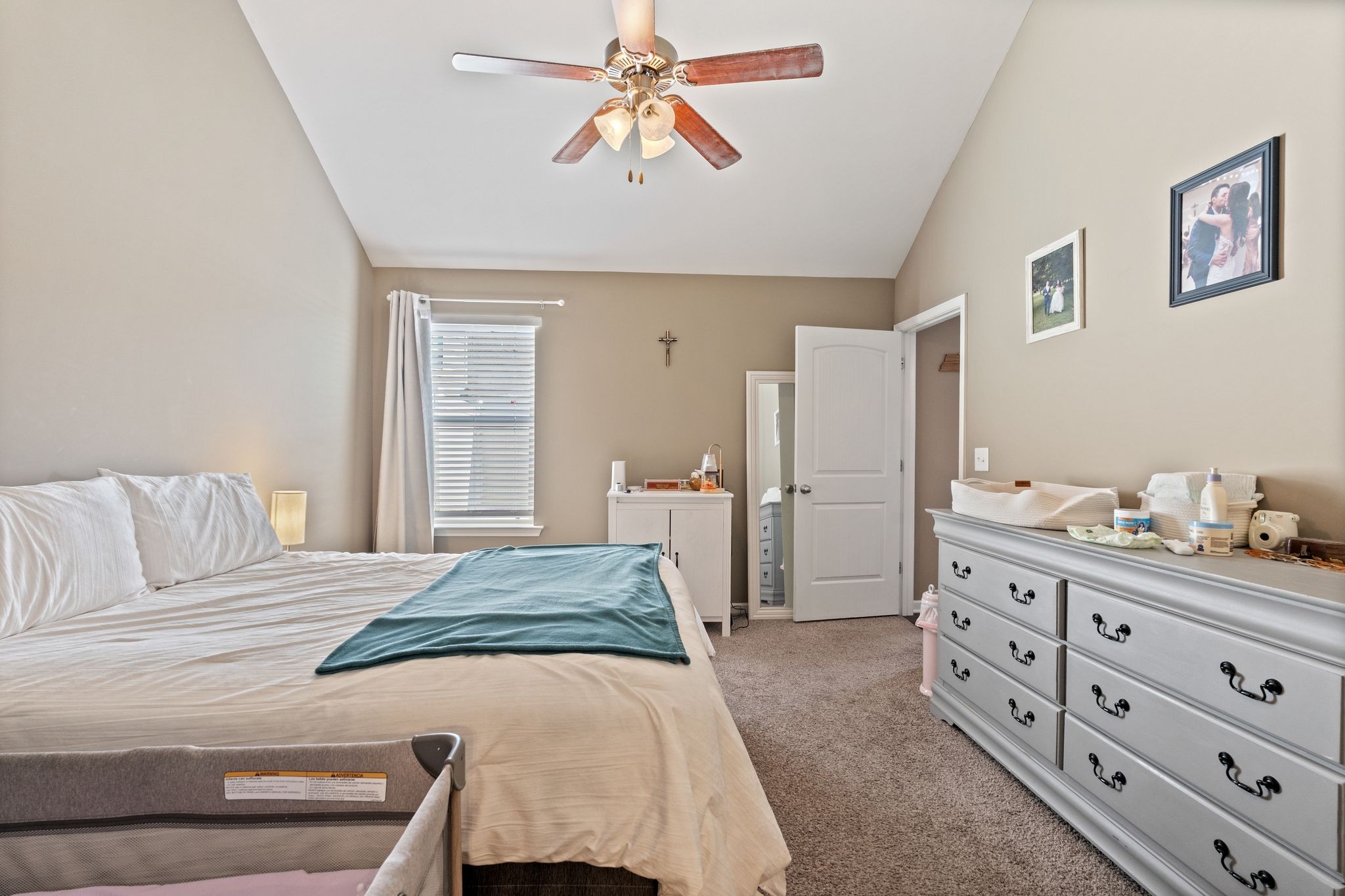 4020 Commons Drive Spring Hill, TN 37174 - Photo 17 of 37 a bedroom with a bed and a chandelier