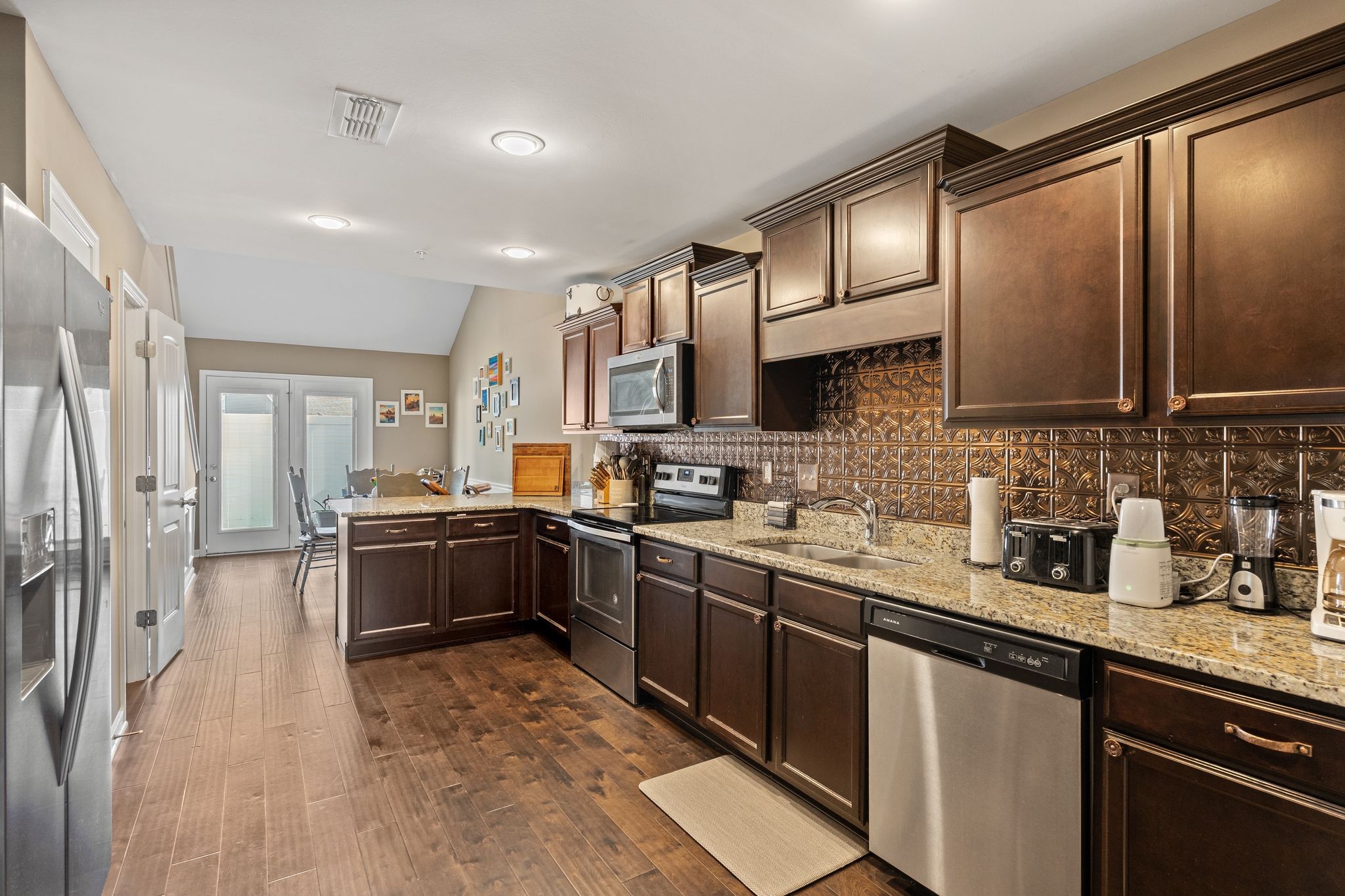 4020 Commons Drive Spring Hill, TN 37174 - Photo 7 of 37 a kitchen with stainless steel appliances granite countertop a sink stove and refrigerator