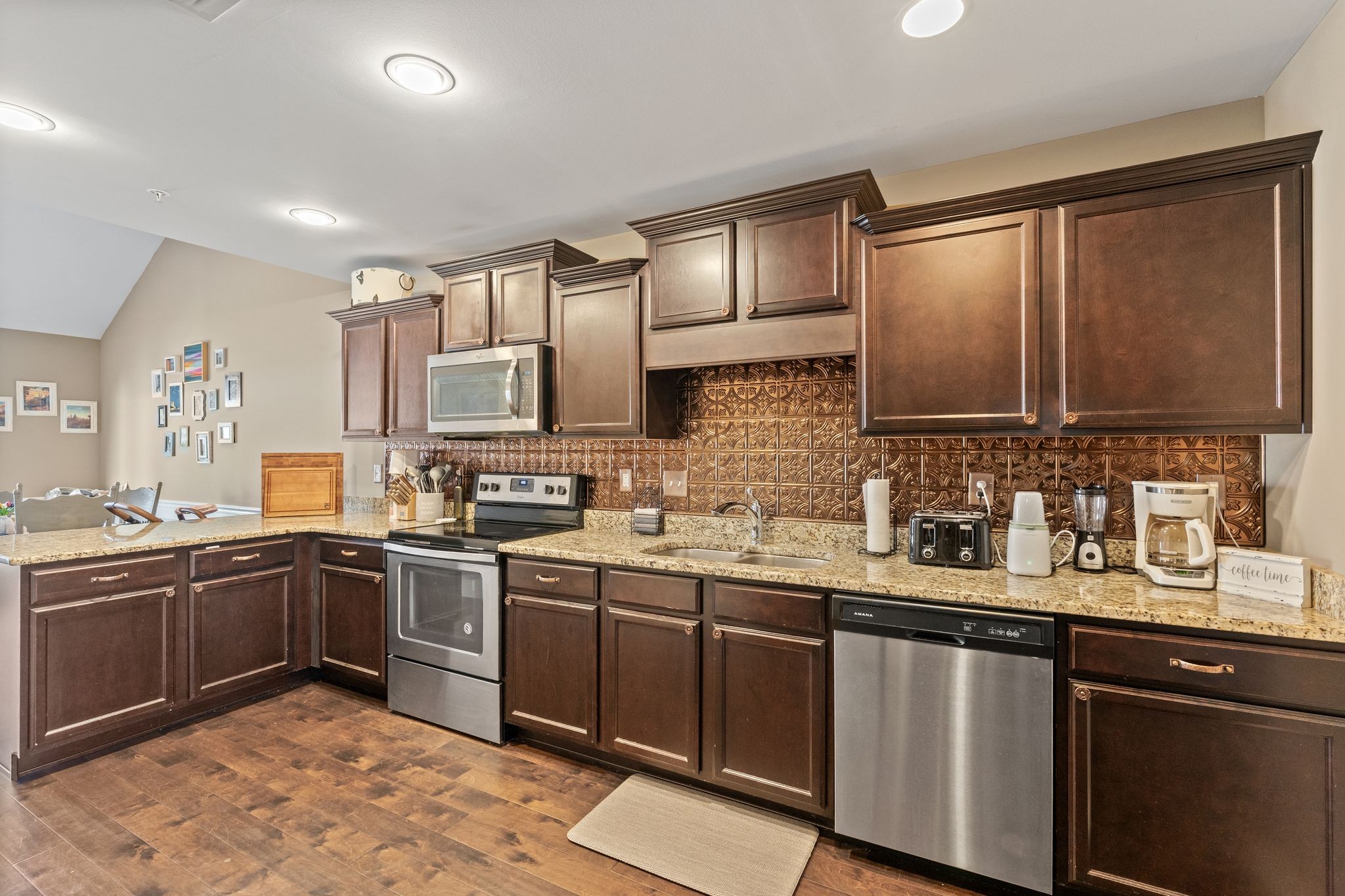 4020 Commons Drive Spring Hill, TN 37174 - Photo 8 of 37 a kitchen with stainless steel appliances granite countertop wooden cabinets a sink and dishwasher