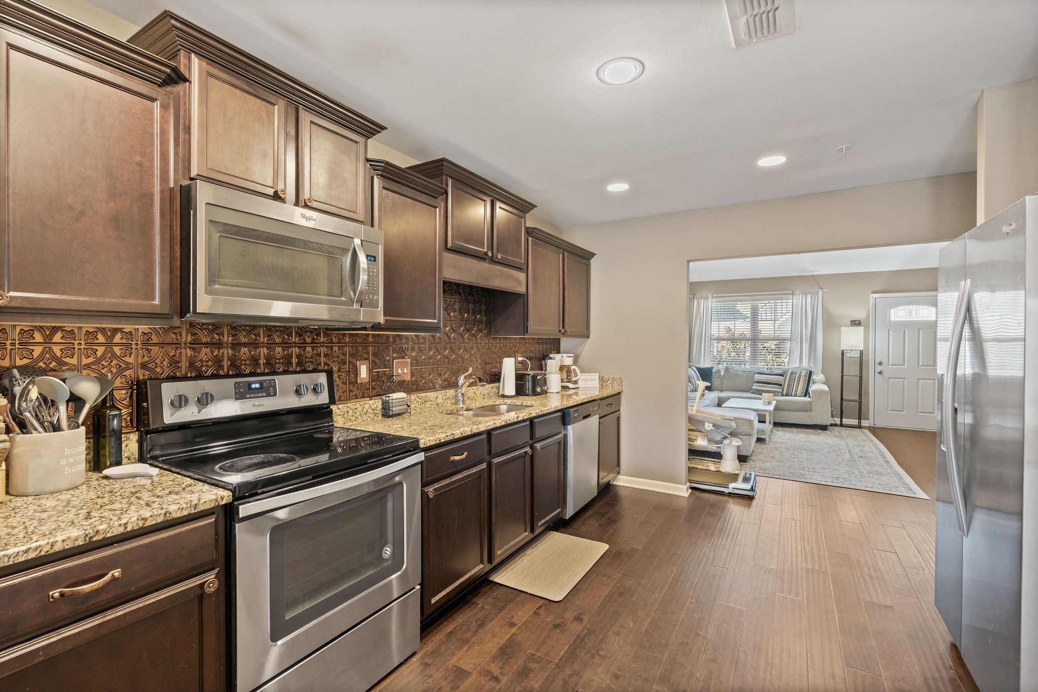 4020 Commons Drive Spring Hill, TN 37174 - Photo 9 of 37 a kitchen with stainless steel appliances granite countertop a sink stove and cabinets