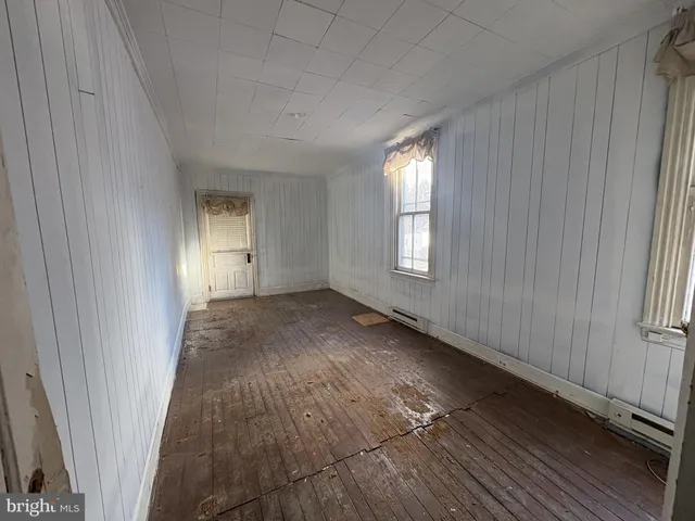 a view of a livingroom with wooden floor and window