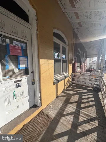a view of a balcony with chair and door