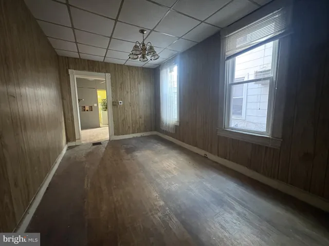 a view of a room with wooden floor and windows