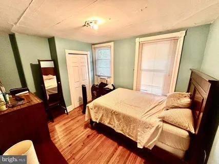 a bed sitting in a bedroom next to a window