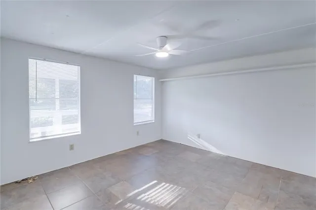 a white house that has tree in front of it