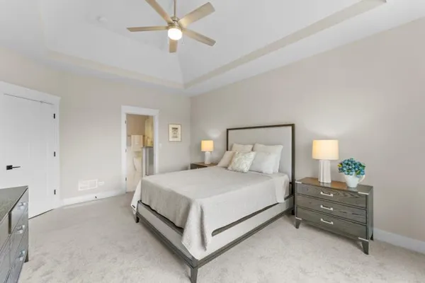a bedroom with a bed and a chandelier