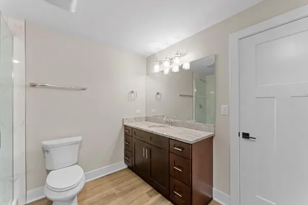 a white toilet sitting next to a bathroom sink