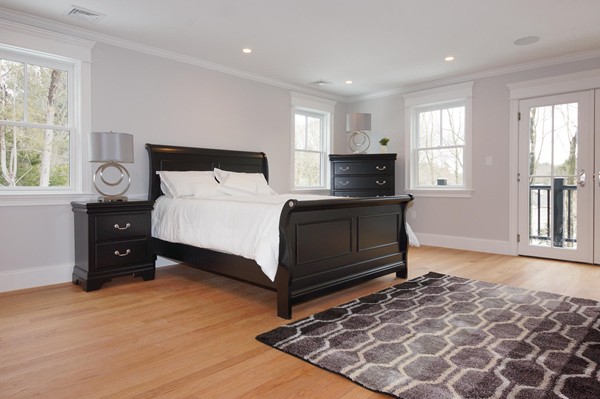 180 Pine Ridge Road Newton, MA 02468 - Photo 13 of 30 a spacious bedroom with a bed and a couch