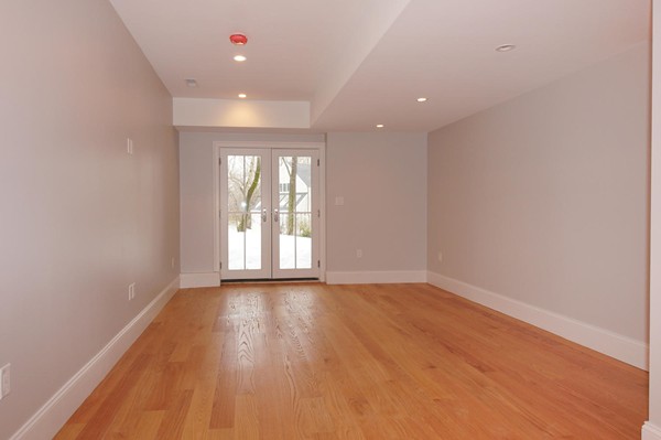 180 Pine Ridge Road Newton, MA 02468 - Photo 25 of 30 a view of an empty room with wooden floor and a window