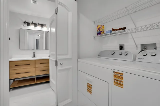 a bathroom with a double vanity sink a toilet and mirror