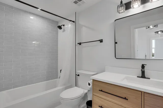 a bathroom with a sink a toilet and a bathtub
