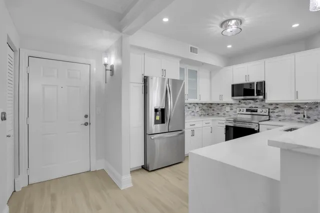 a kitchen with a refrigerator sink and microwave
