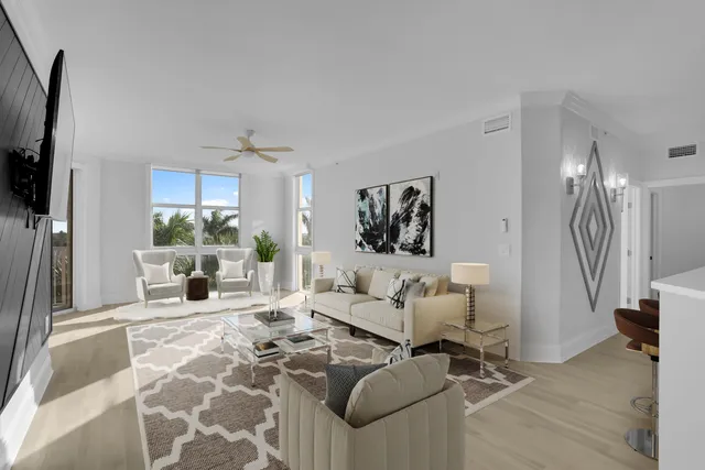 a living room with furniture large window and a flat screen tv