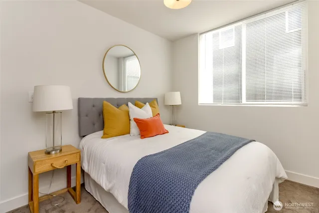 a bedroom with bed and a window