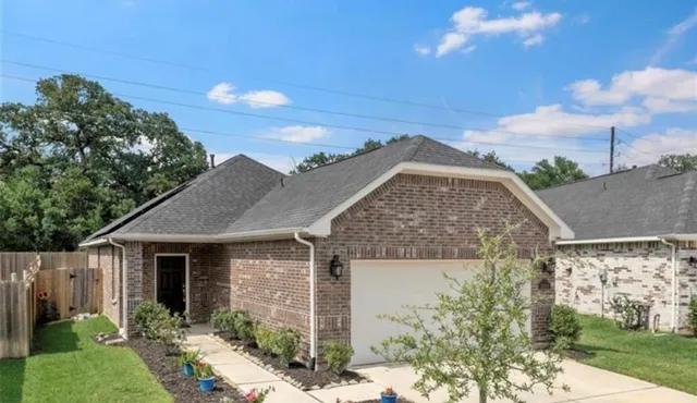 a view of a house with a yard and potted plants