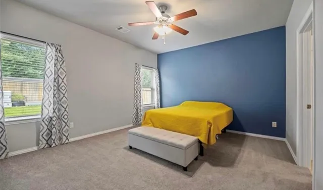 a bed sitting in a room next to a window