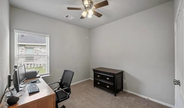 a view of workspace with furniture and a window