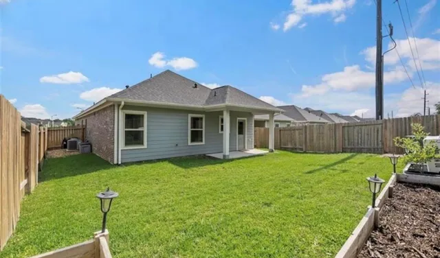 a backyard of a house with table and chairs