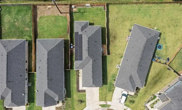 an aerial view of a residential houses with outdoor space and swimming pool