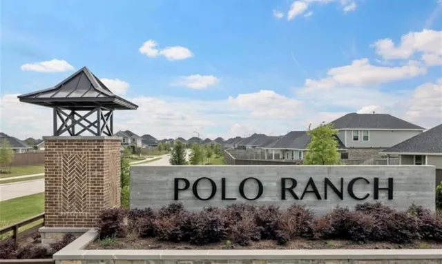 a sign board with buildings in the background