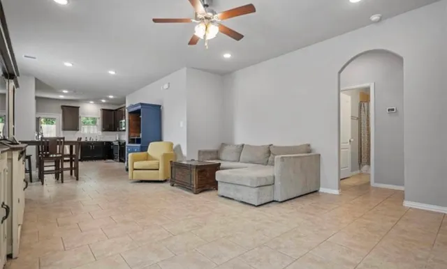 a living room with furniture and kitchen view