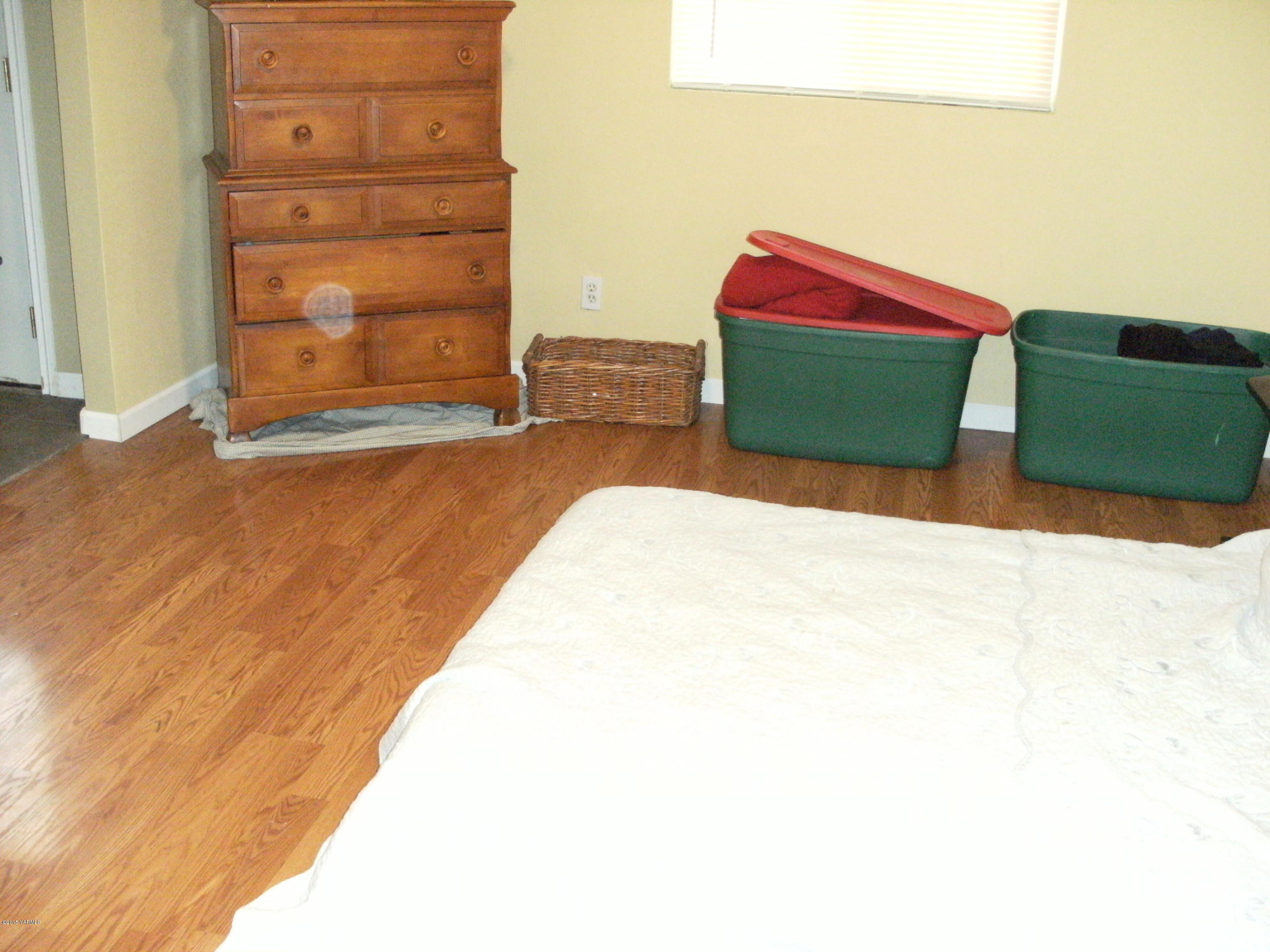 1180 Woodworth Road Grandview, WA 98930 - Photo 11 of 26 a bedroom with a bed and a dresser
