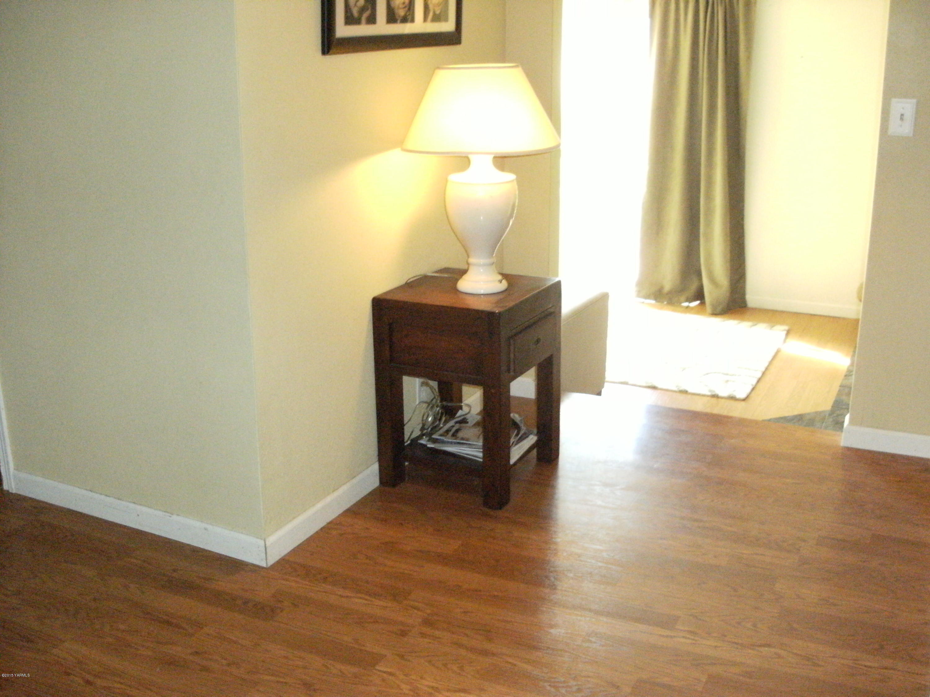 1180 Woodworth Road Grandview, WA 98930 - Photo 7 of 26 a view of a room with wooden floor and a table