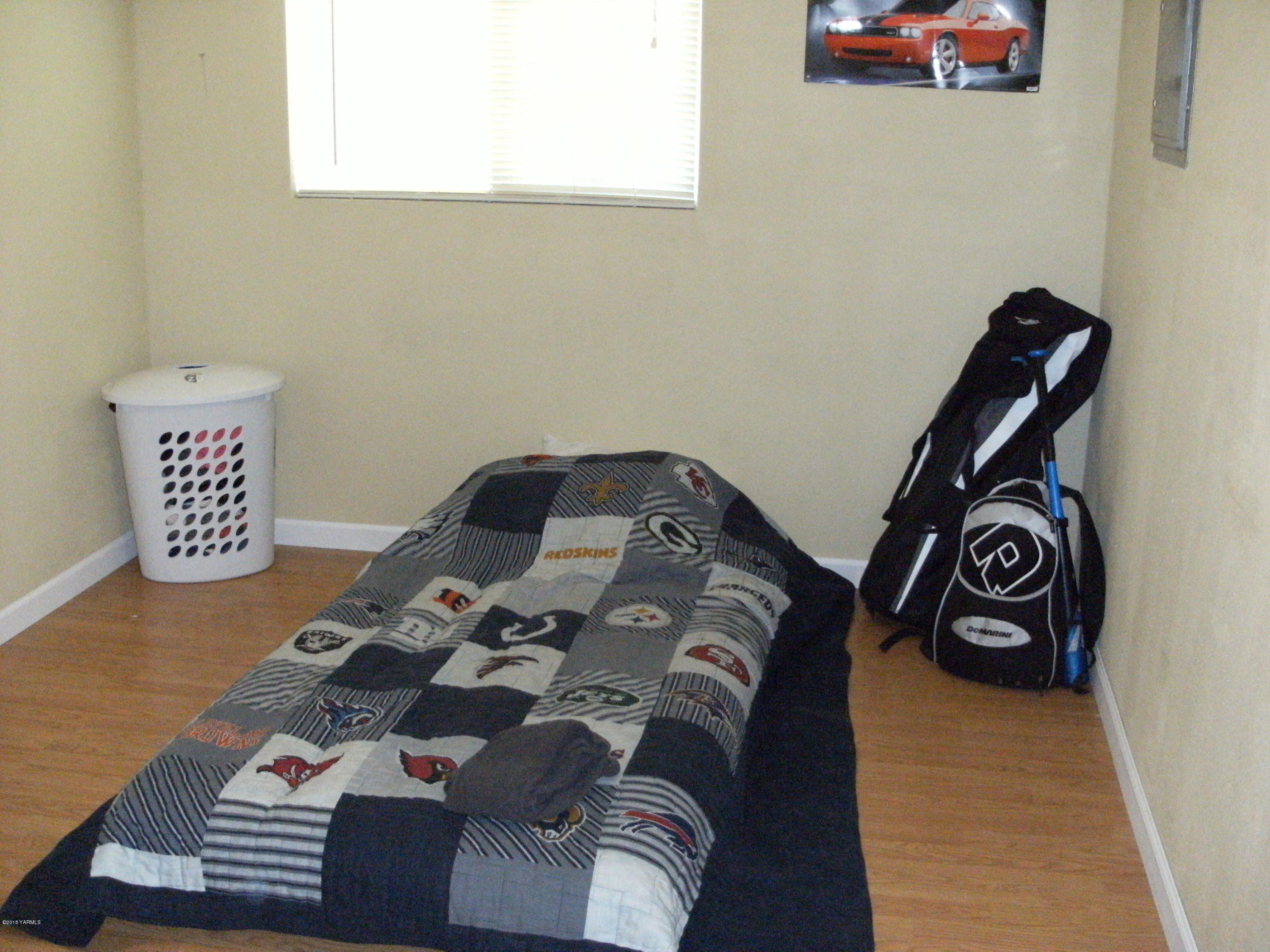 1180 Woodworth Road Grandview, WA 98930 - Photo 9 of 26 a bedroom with a bed and a window