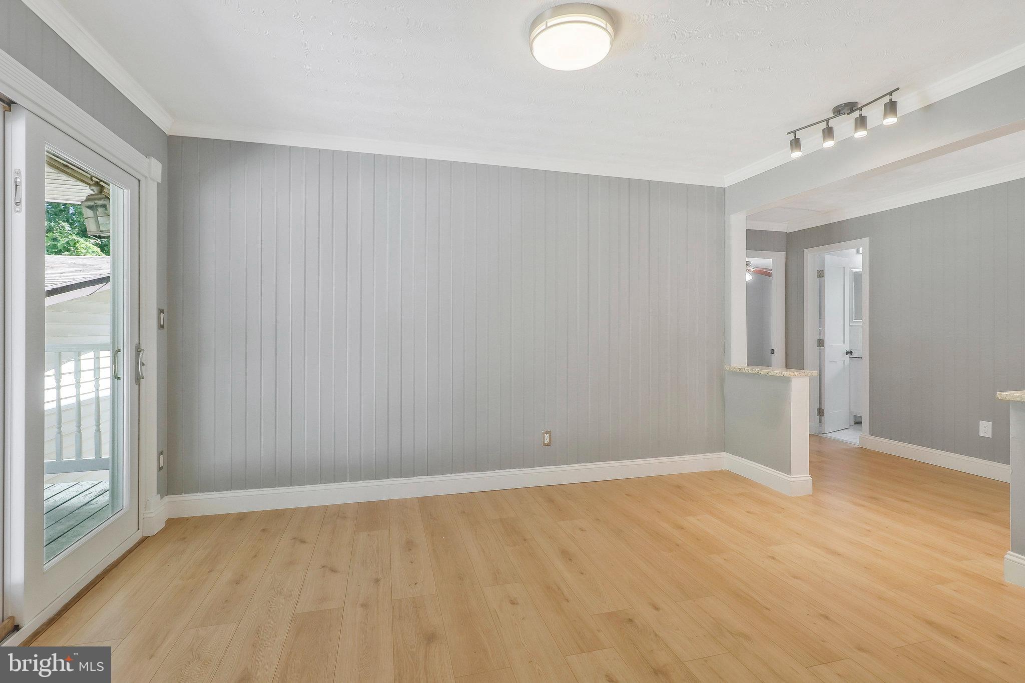 9600 Woodland Avenue Lanham, MD 20706 - Photo 12 of 41 a view of an empty room with wooden floor and a window
