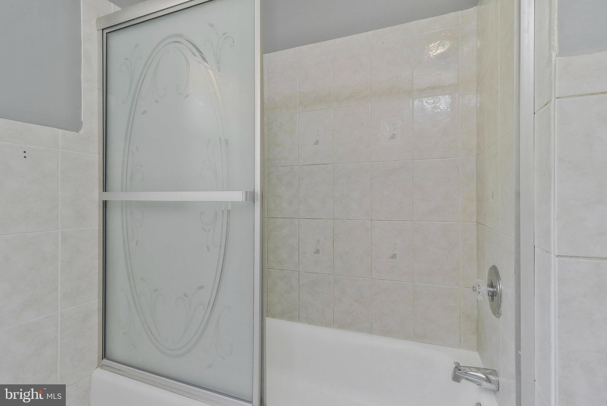 9600 Woodland Avenue Lanham, MD 20706 - Photo 18 of 41 a bathroom with a glass shower door