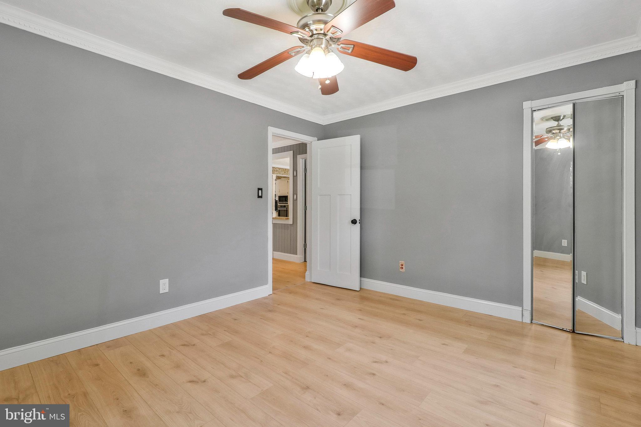 9600 Woodland Avenue Lanham, MD 20706 - Photo 20 of 41 an empty room with closet and a chandelier fan