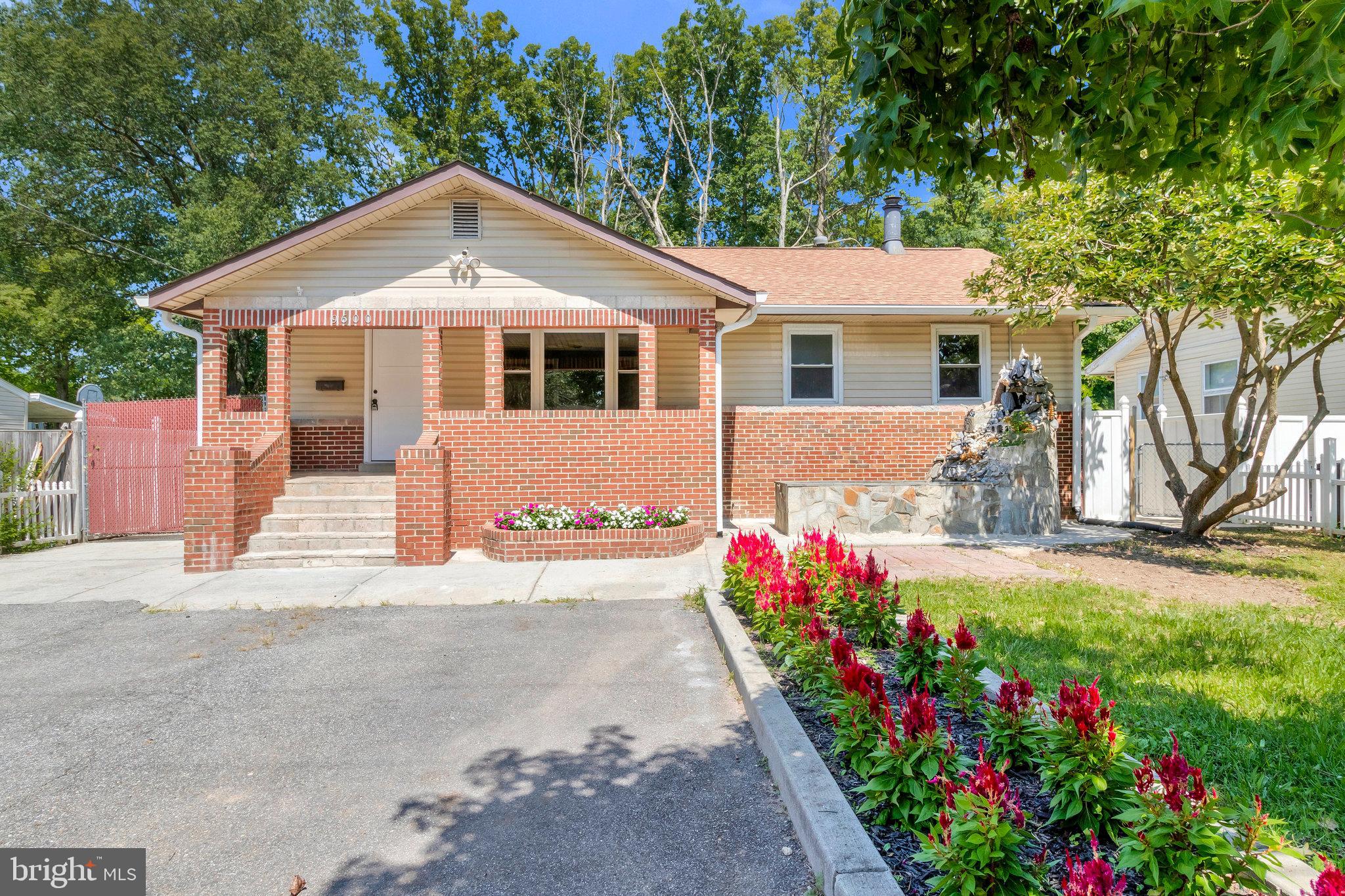9600 Woodland Avenue Lanham, MD 20706 - Photo 2 of 41 a front view of a house with a yard