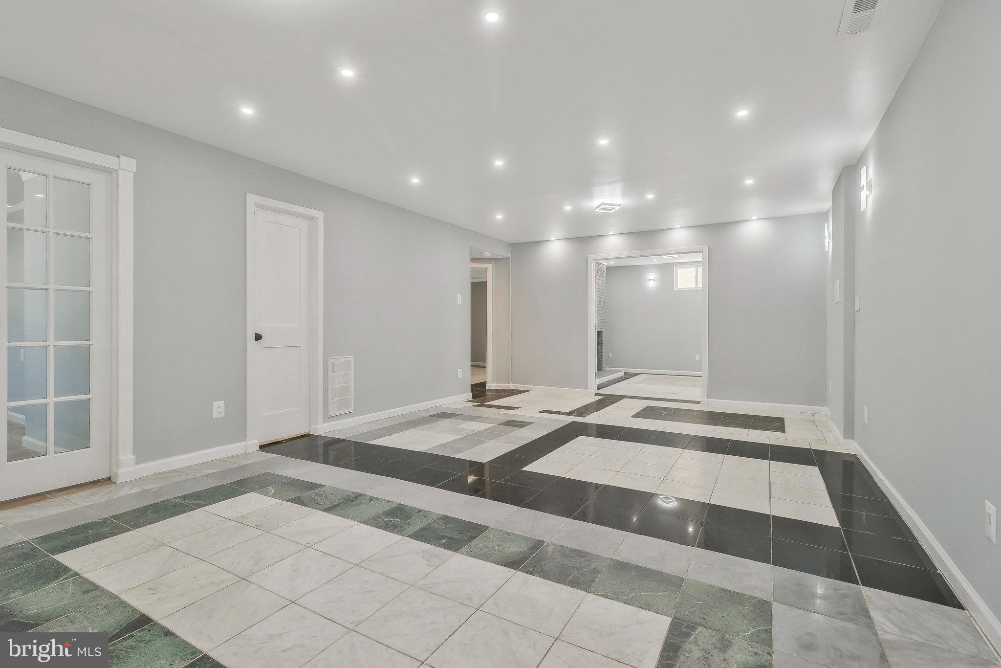 9600 Woodland Avenue Lanham, MD 20706 - Photo 27 of 41 a view of a hallway with granite countertop white cabinets and stainless steel appliances
